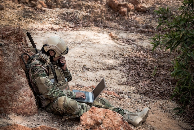 Soldiers of special forces on wars at the desertThailand peopleArmy soldier use laptop for see map with satelliteUsing Radio For Communication During Military Operation