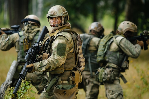 Soldiers standing with arms and looks back