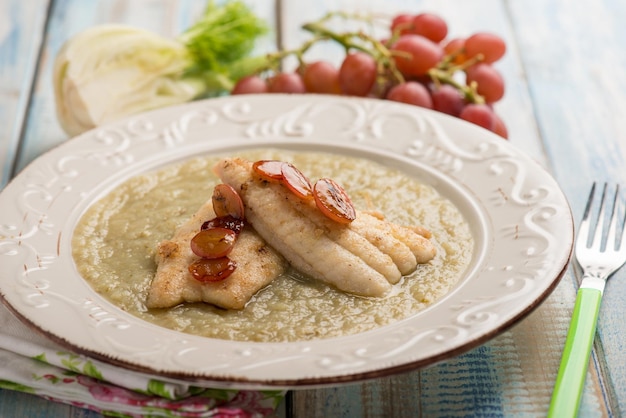 Sole fish with fennel cream and grape