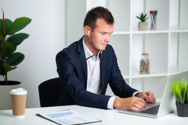 Solid businessman in a jacket works in office of the company