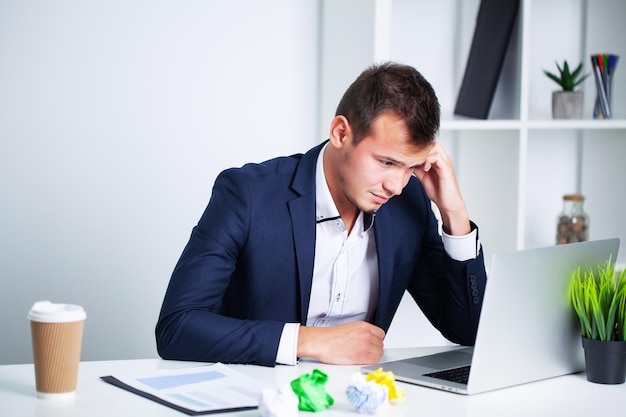 Solid businessman in a jacket works in office of company.