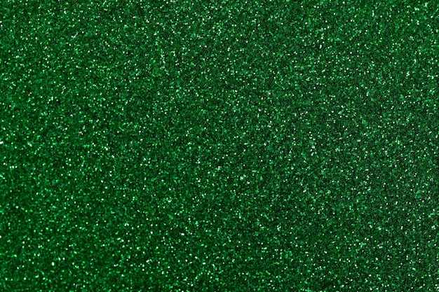 Solid color emerald glitter background with depth of field background with sparkles and glitters