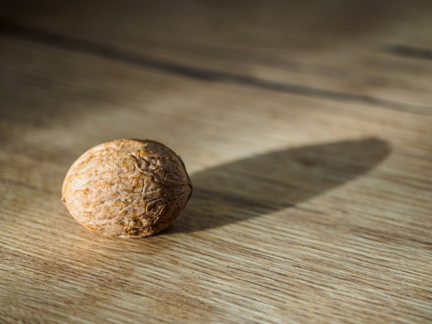 Solid walnut and its shadow on the wooden surface