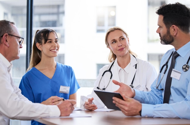 Solving health problems one meeting at a time. Shot of a group of doctors in a meeting at a hospital.