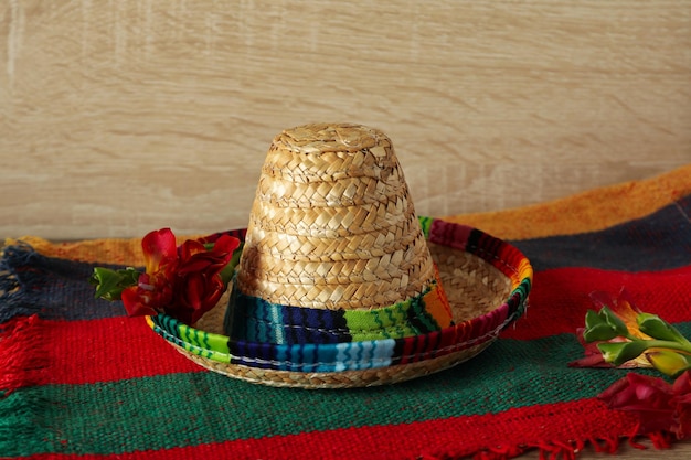 Sombrero with fresh flowers on a wooden background