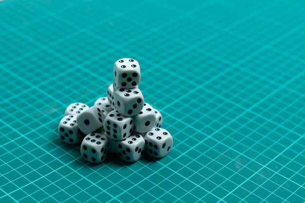 Some dice game cubes with black dots on color surface