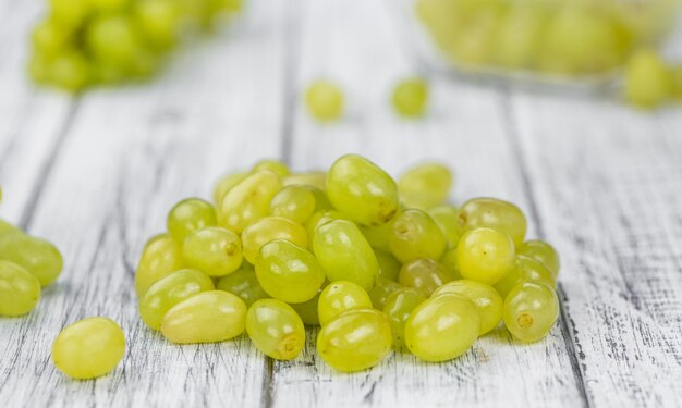 Some fresh White Grapes on wooden background selective focus closeup shot