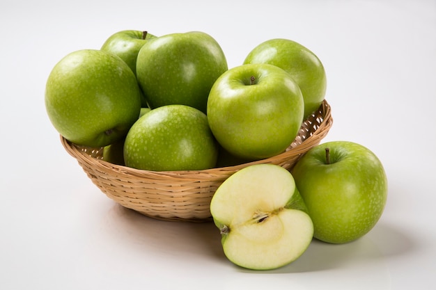 Some green apples on a white surface. Fresh fruits