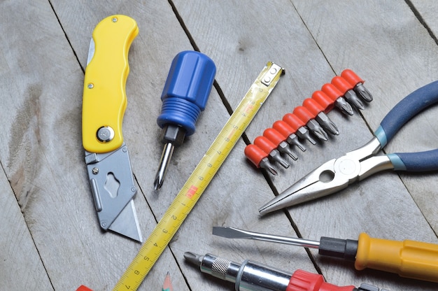 some home repair tools lie on a wooden background. close-up.