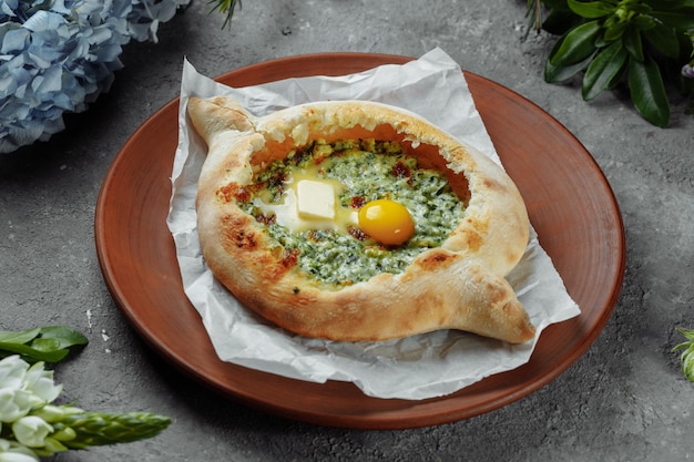 Some khachapuri traditional Georgian homemade cheese and spinach pies on the plate