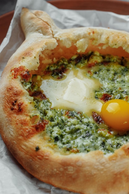 Some khachapuri traditional Georgian homemade cheese and spinach pies on the plate