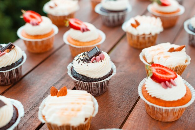 Some tasty cupcakes  arranged on a wooden table