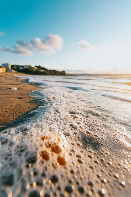 Some tides with bubbles in the beach at the city during a super colorful sunshine 