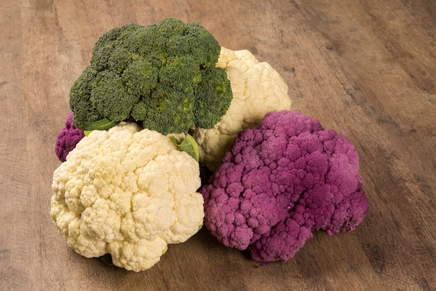 Some white cauliflowers over a wooden surface seen from above. Fresh vegetable.