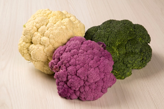 Some white cauliflowers over a wooden surface seen from above. Fresh vegetable.