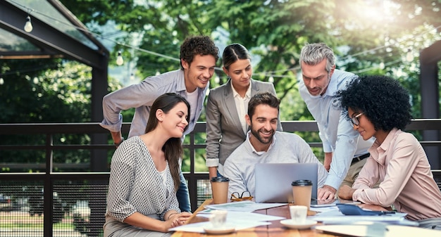 Sometimes a change in scenery is just whats needed Cropped shot of a group of business colleagues having a meeting outdoors at a cafe