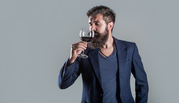 Sommelier, degustator with glass of wine, winery, male winemaker. 