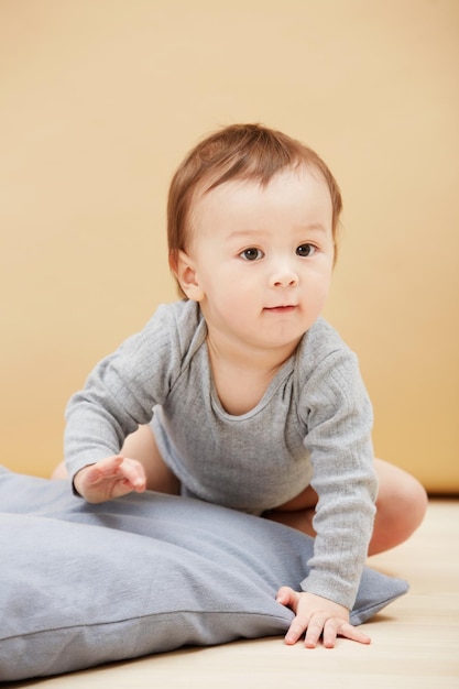 Soon hell be walking Portrait of a cute infant crawling on the floor and smiling at the camera