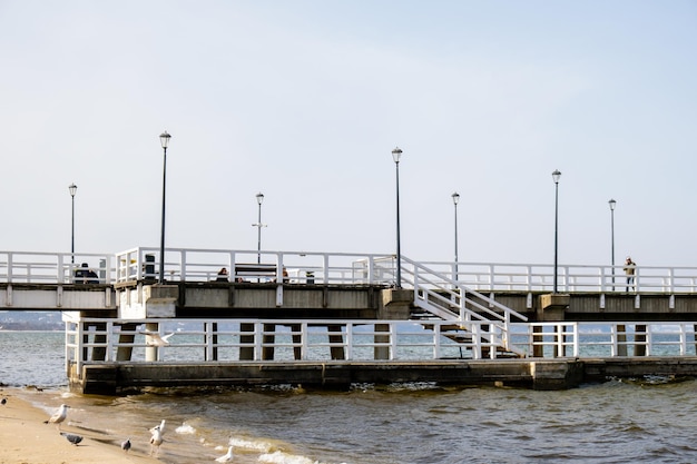 The Sopot molo pier longest in Europe Baltic Sea and the sun Seagulls flying on the beach of Baltic Sea waves searching food Holiday vacation