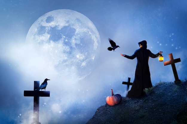 The sorcerer and birds in the cemetery at the moon Mystical image Halloween