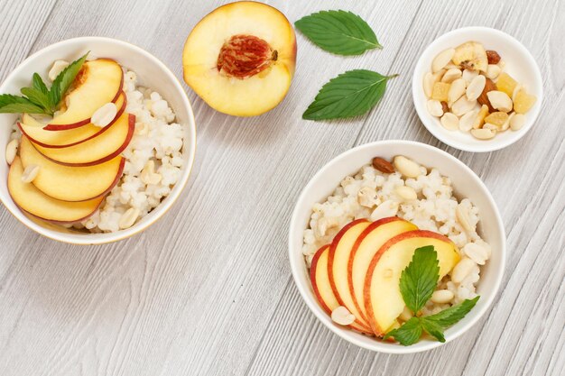 Sorghum salad with nuts and fresh peach on wooden board