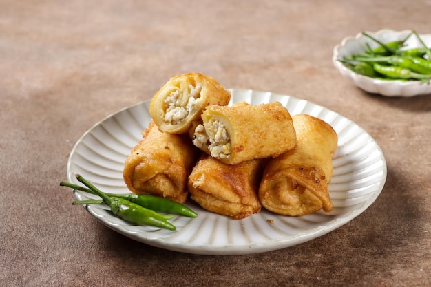 Sosis Solo is Indonesian traditional fried egg crepe with sweet and minced chicken filling.