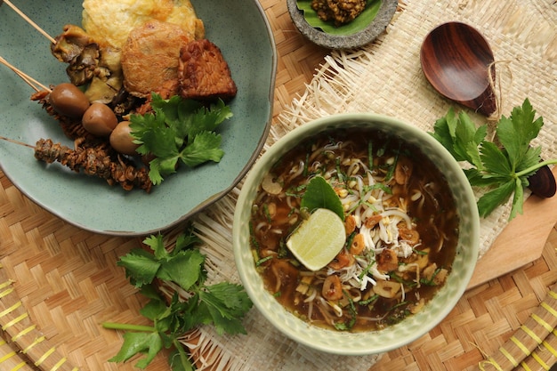 Soto ayam kudus  javanese chicken soup dish with extra side dishes from kudus central java