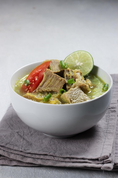 Photo soto sapi or soto daging, is an indonesian special soup made from beef broth with meat cutlet.