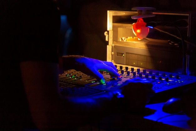 Soundman working on the mixing console