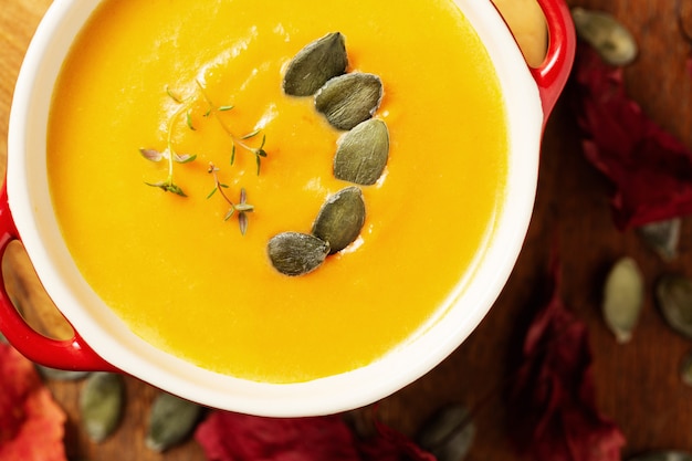 Soup pumpkin, sweet potato, carrot   with pumpkins seeds and thyme leaves