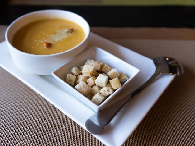 Soup puree sprinkled with sesame seeds, croutons of white bread. Japanese food in the restaurant.