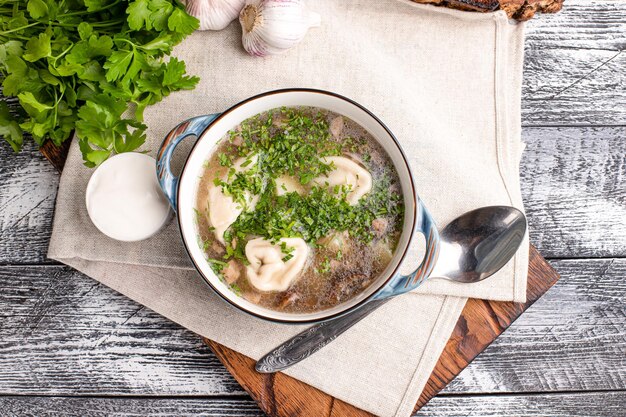 Soup with dumplings soup with homemade dumplings on a wooden white background