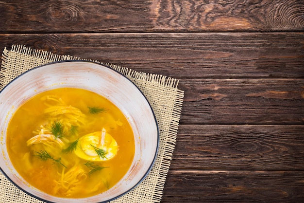 Soups in plates on wooden background