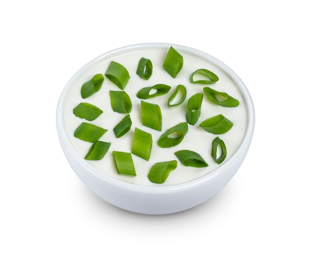 Sour cream and green onion isolated on white