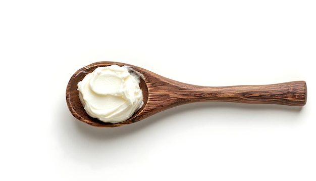 Sour cream in wooden spoon on white background