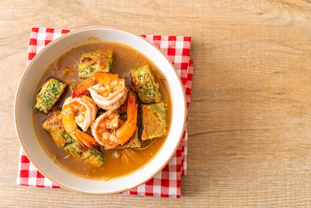 Sour soup made of Tamarind Paste with Shrimps and Vegetable Omelet - Asian food style