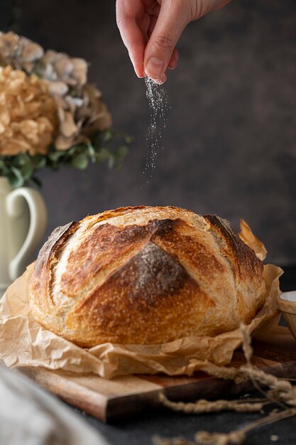 Sourdough artisan homemade bread, pouring sald over bread, selective focus, movement photo