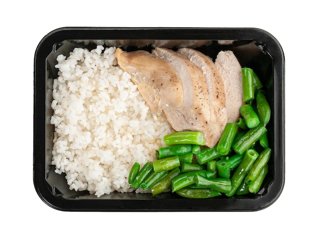 Sous vide chicken fillet with rice and green beans In a food delivery container White background View from above Isolated