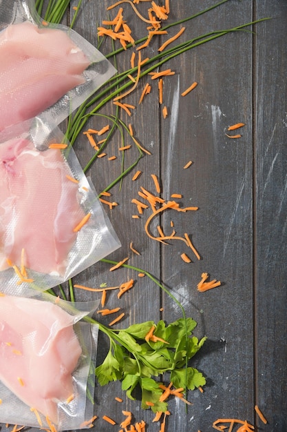 Sous Vide cooking concept Vacuum packed ingredients arranged on wooden dyed background