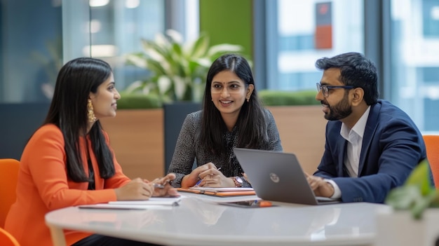 South Asian financial experts collaborating on a banking project discussing data on a laptop