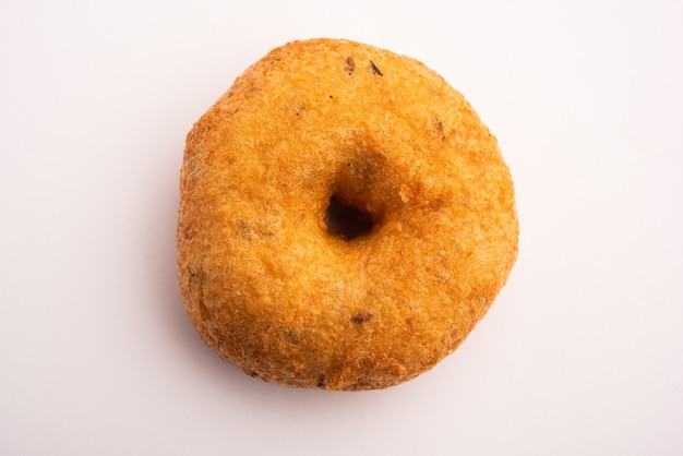 South Indian Vada, Medu vada or dal vadai in plate or bowl, isolated on plain