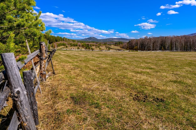 South Ural farm wooden fence and arable land with a unique landscape vegetation and diversity of nature