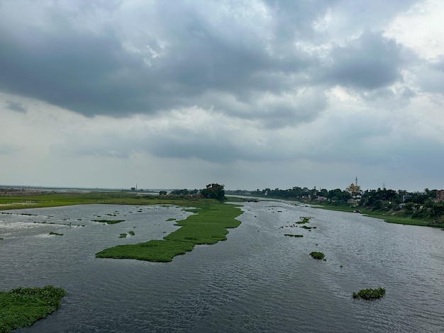 Southeast Asian waterway scenery Beautiful cloudy sky and river view Twilight time sky scenery with dark clouds and cloudy sky Scenic river flow view with thick dark clouds in a rainy season