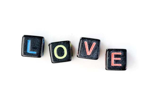 Souvenir cubes with letters crossed in the word love Isolated