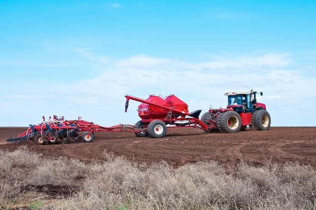 Sowing. Tractor with seeder in the field