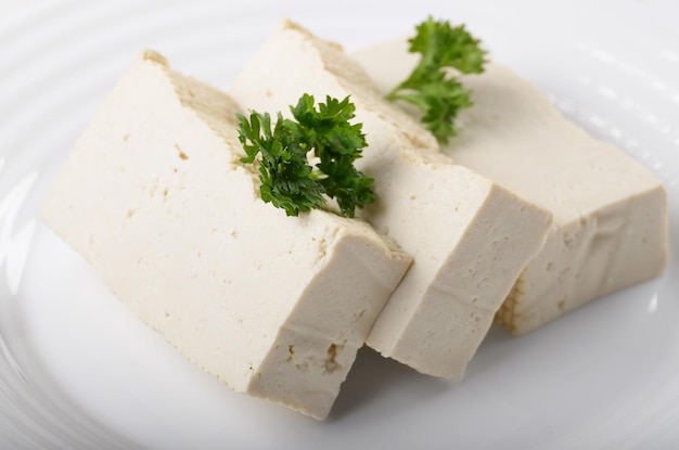 Soy Bean curd tofu on clay dish closeup Nondairy alternative substitute for cheese