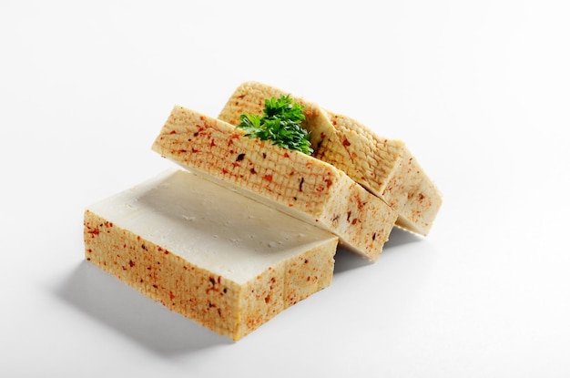 Soy Bean curd tofu with greens on white background Nondairy alternative substitute for cheese