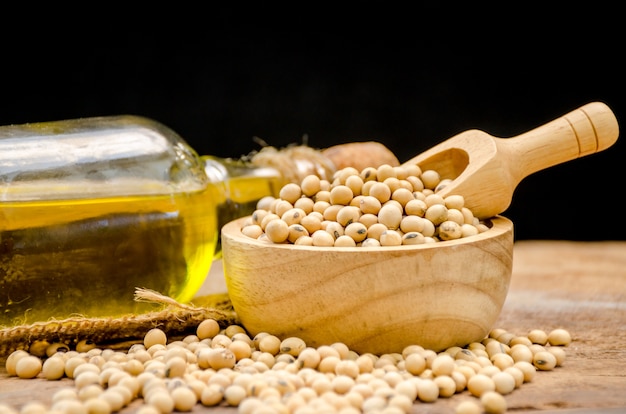 Soy bean and soy oil on wooden table