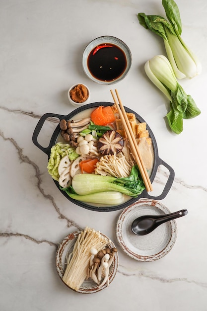 Soy Milk Hot Pot recipe with napa cabbage mushrooms and thinly sliced pork cooked in a creamy and savory soy milk broth