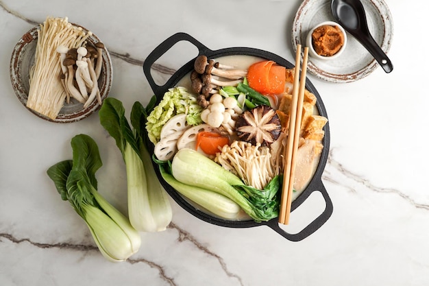 Soy Milk Hot Pot recipe with napa cabbage mushrooms and thinly sliced pork cooked in a creamy and savory soy milk broth